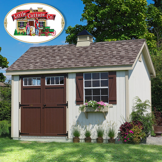 Shed with brown door in backyard. Pink flowers in flower pots.