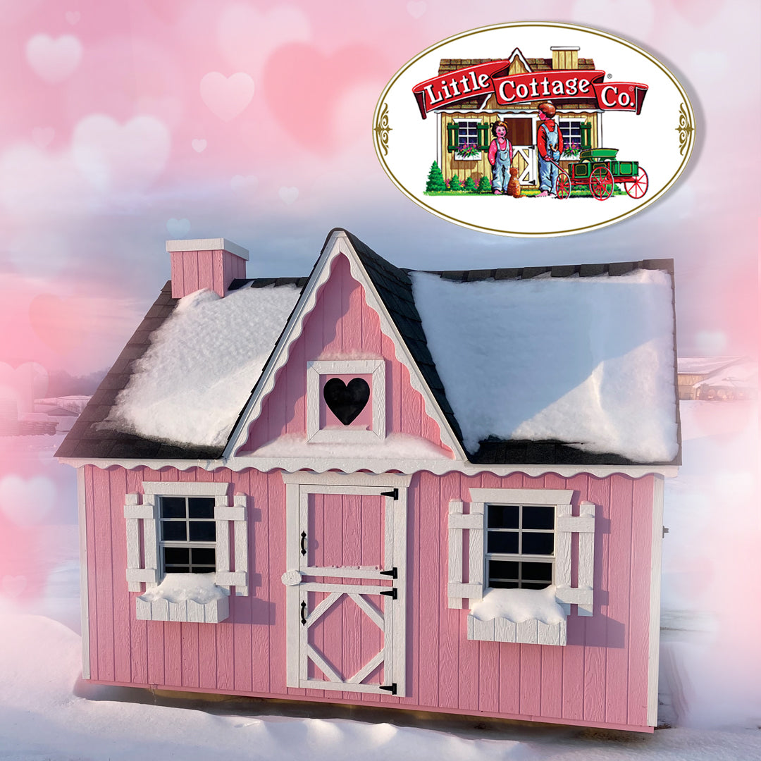 Pink playhouse with white gingerbread trim covered in snow in winter. Pink background with hearts.